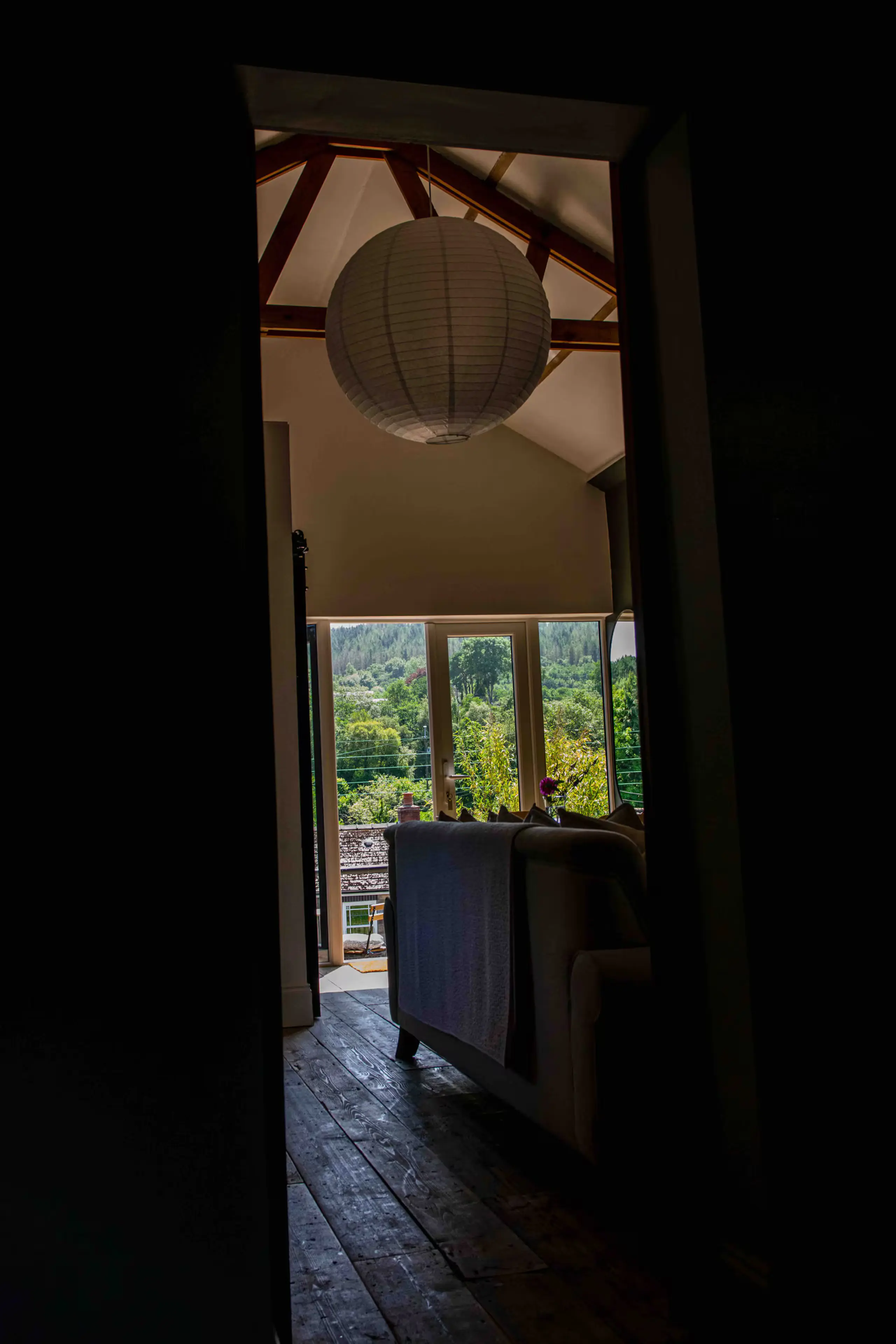 View through the reclaimed barn door into the vaulted living space
